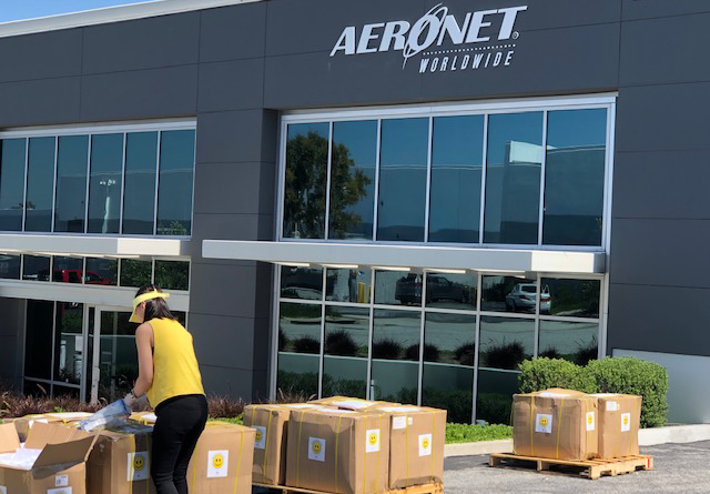 Operation Be Kind volunteer organizing of shipment of surgical masks in front of Aeronet Los Angeles.