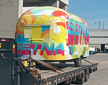 Airstream trailer loaded onto a flatbed trailer, and ready for transport